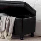 Banc de rangement capitonné noir avec revêtement en similicuir et pieds en bois tournés, Banc Ottoman de rangement