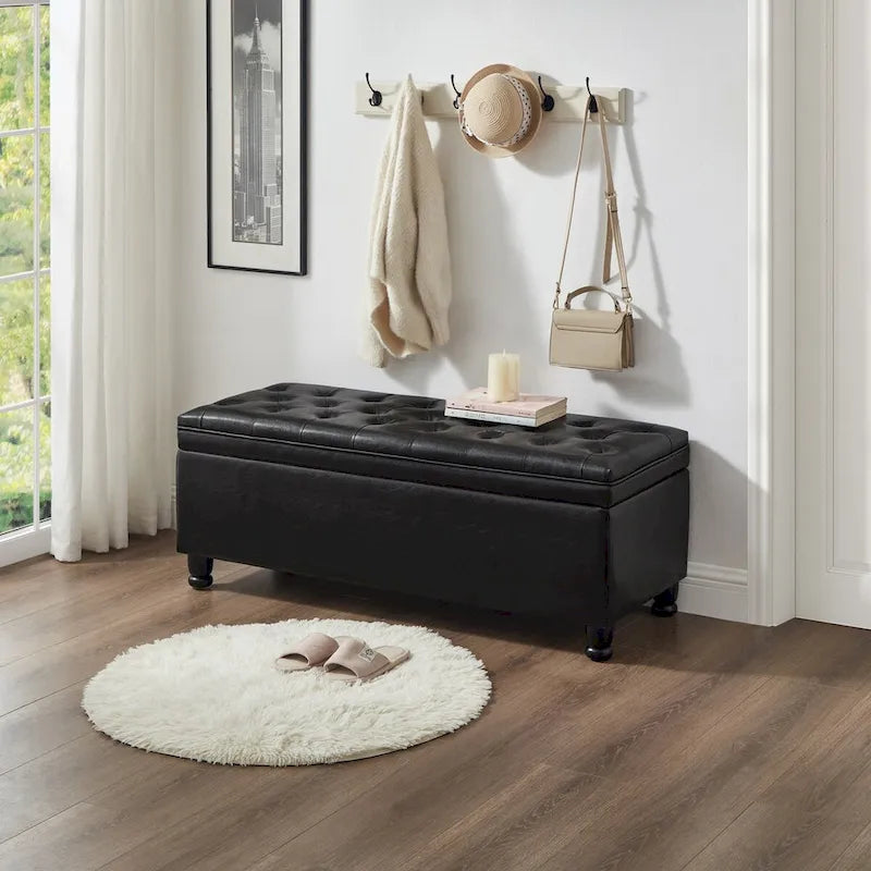 Banc de rangement capitonné noir avec revêtement en similicuir et pieds en bois tournés, Banc Ottoman de rangement